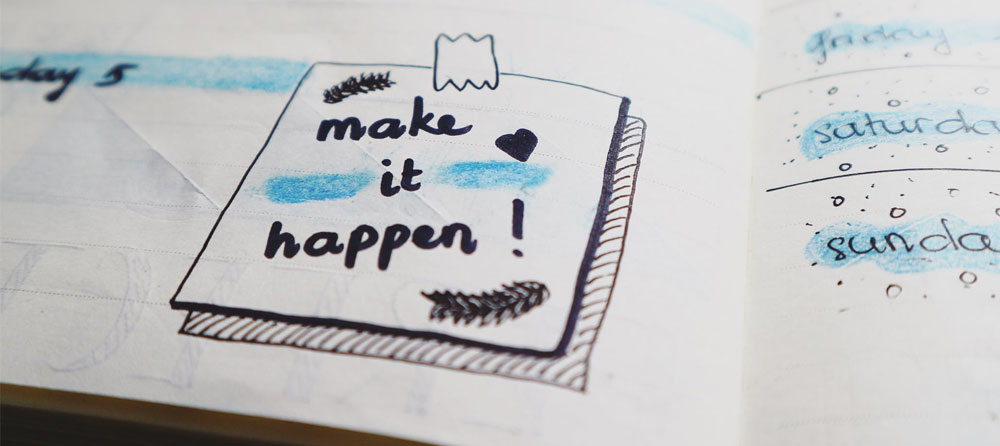 A diary with 'Make it Happen' written in